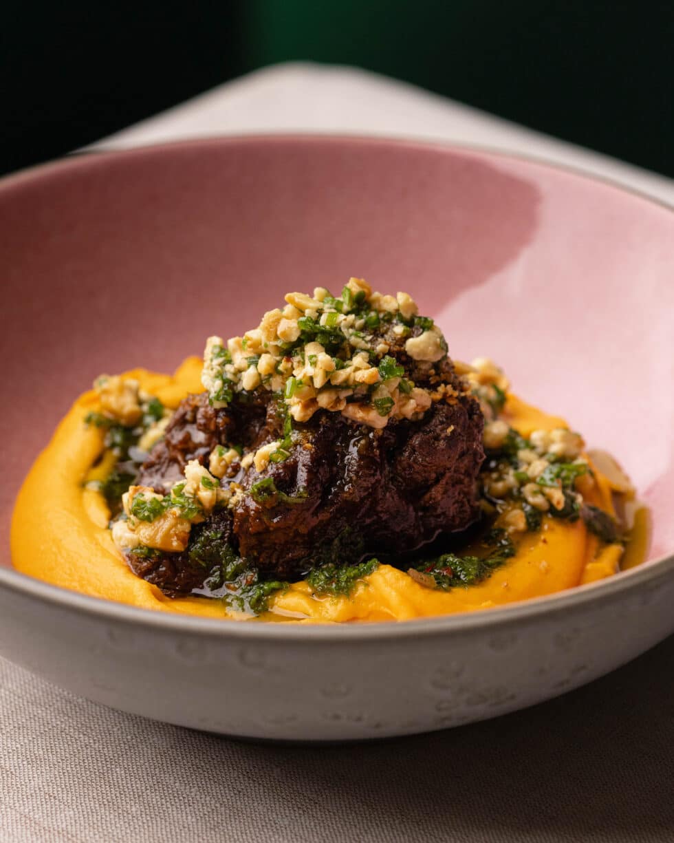 a bowl of food with meat and vegetables